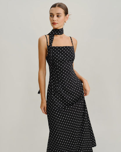 Vestido slip longo preto com estampa de poás e decote drapeado